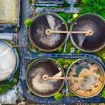 Aerial shot of a water treatment plant in Serang, Indonesia with circular tanks.
